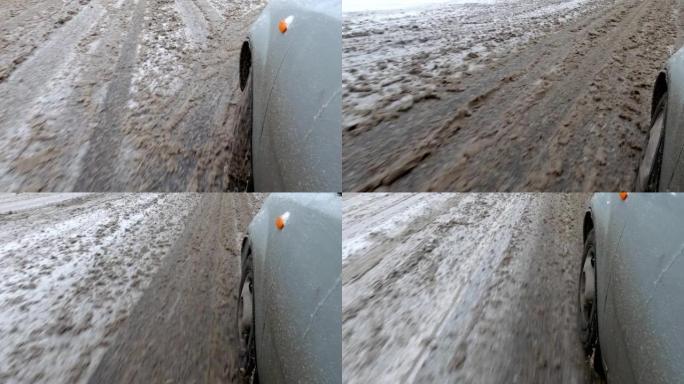 凌乱的冬季道路雪泥前轮移动汽车