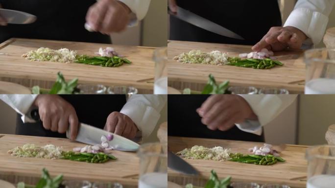 由专业厨师用菜刀将小葱，红洋葱在木制切菜板上切成薄片。