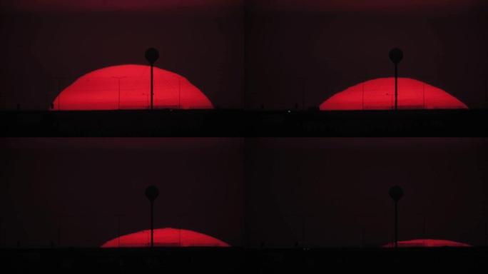 通过长焦镜头拍摄的大红橙色日落。