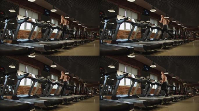 运动员正在改善自己的身体，在健身房的跑步机上做有氧运动。