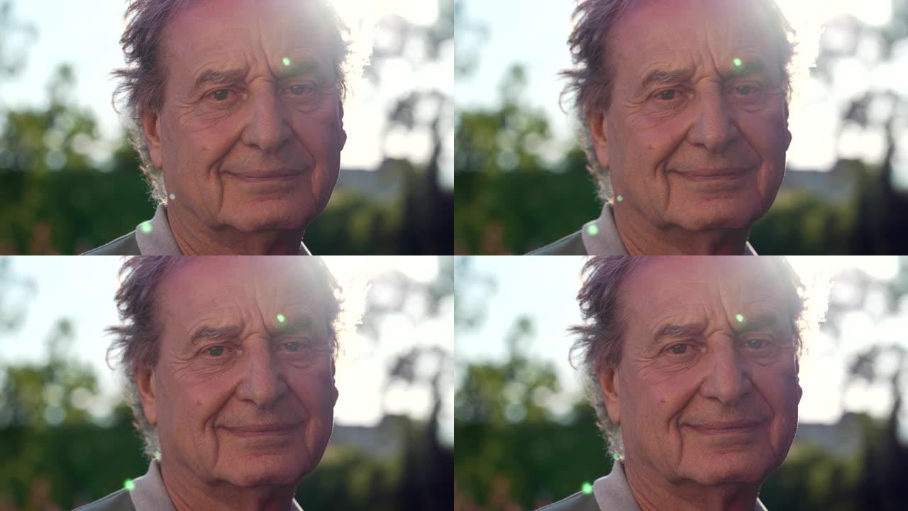 一个成熟的男人站在阳光下对着镜头微笑。70年代一位高级男性看着相机的肖像