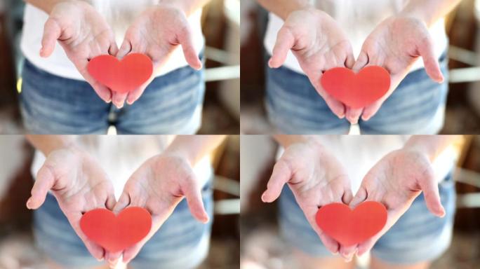 情人节特写4k电影慢动作女性手握红纸心
