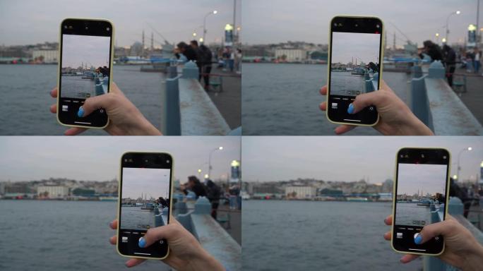 黄昏时间伊斯坦布尔市著名渔夫桥电话图片制作慢动作全景4k土耳其