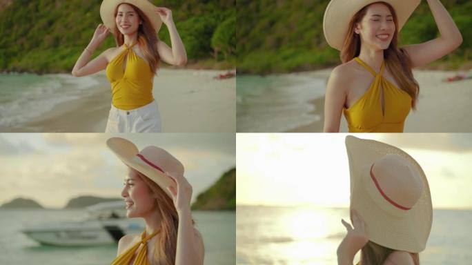 傍晚，太阳是日落，美丽的亚洲女孩穿着草帽，在度假，自由，旅行，冒险的概念在沙滩上散步。