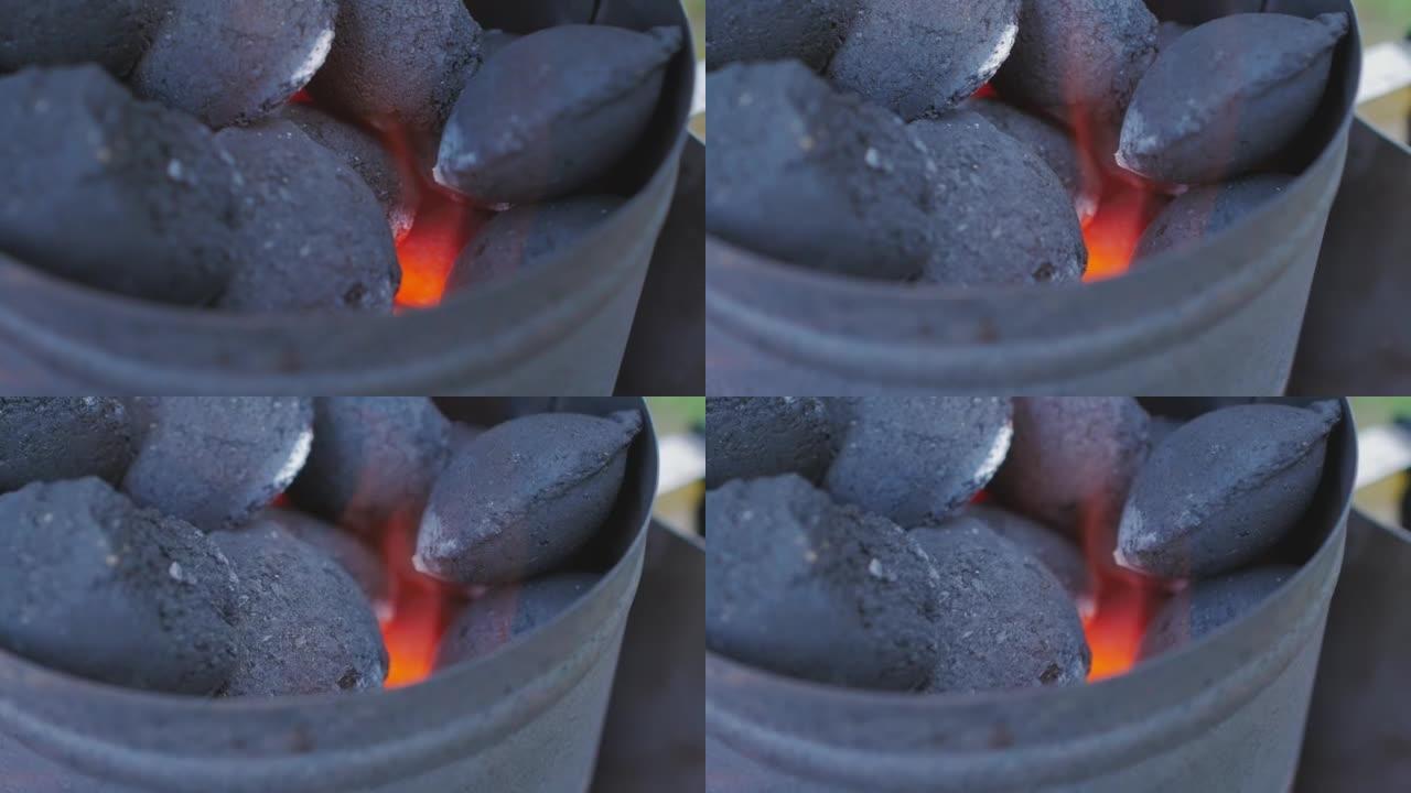 烧烤炉坑中燃烧的热木炭煤块的特写镜头