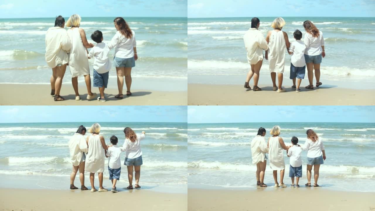 夏天，亚洲家庭与Granmother在海滩上度过了愉快的时光。多代关系的概念