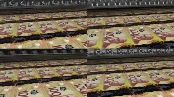 加拿大，加拿大元印刷机打印出当前100美元纸币，无缝循环，加拿大货币背景，4K，聚焦深度Smoot和