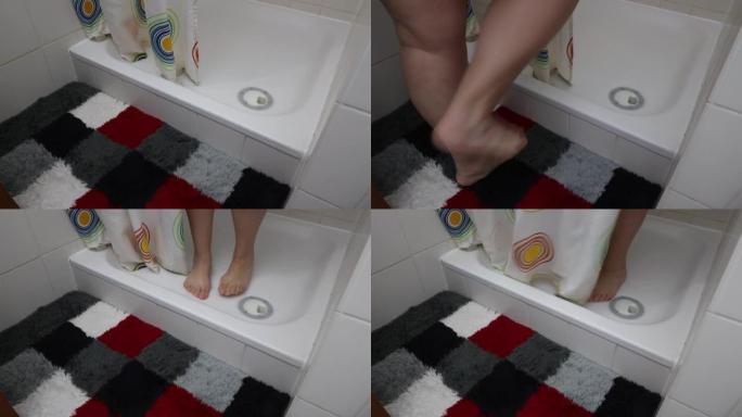 女性的腿走路和进入淋浴，关闭浴帘