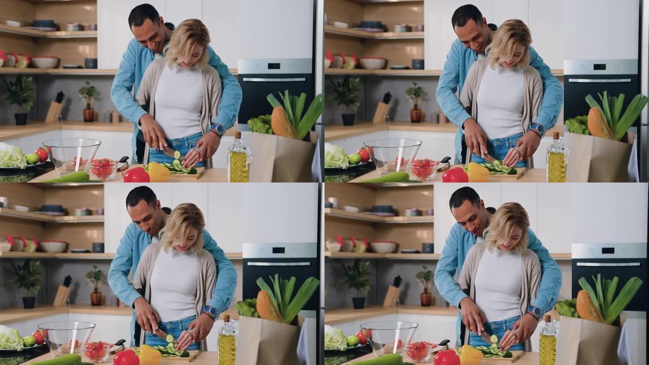 快乐的男人和女人在家庭厨房里用有趣的时刻准备和烹饪健康的蔬菜沙拉。夫妻做饭聊天一起笑准备健康餐享受食