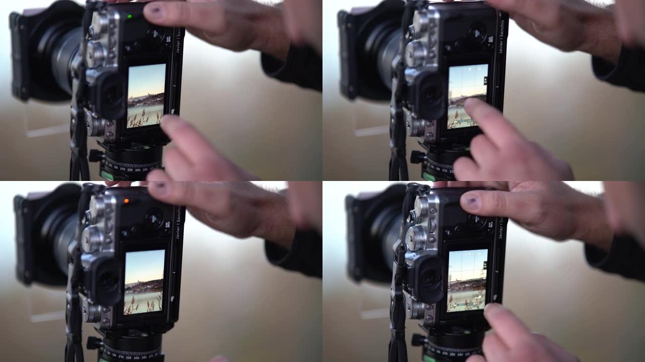 男子修理专业相机的工具，以捕捉秋天的日落和湖景