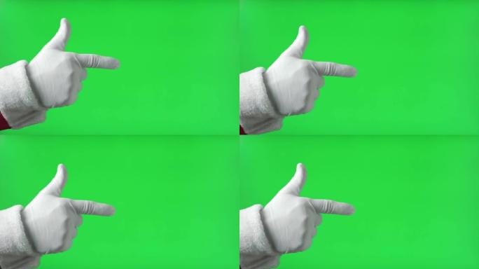 圣诞老人的手指向前面，食指隔离在绿色背景上。特写。戴着手套的白手用一根手指向前指向某物。色度键屏幕。