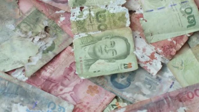 镜头4K。现金，泰国纸币，破损，撕裂，破损，流通货币，泰铢是泰国的官方货币。