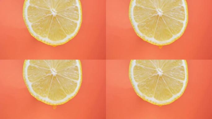 柠檬汁从果肉中流出，并在橙色背景上滴落，宏观视频，文字运动
