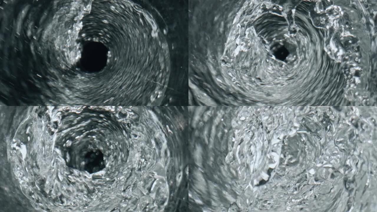 水旋流透明玻璃俯视图。带有气泡的液体涡旋特写