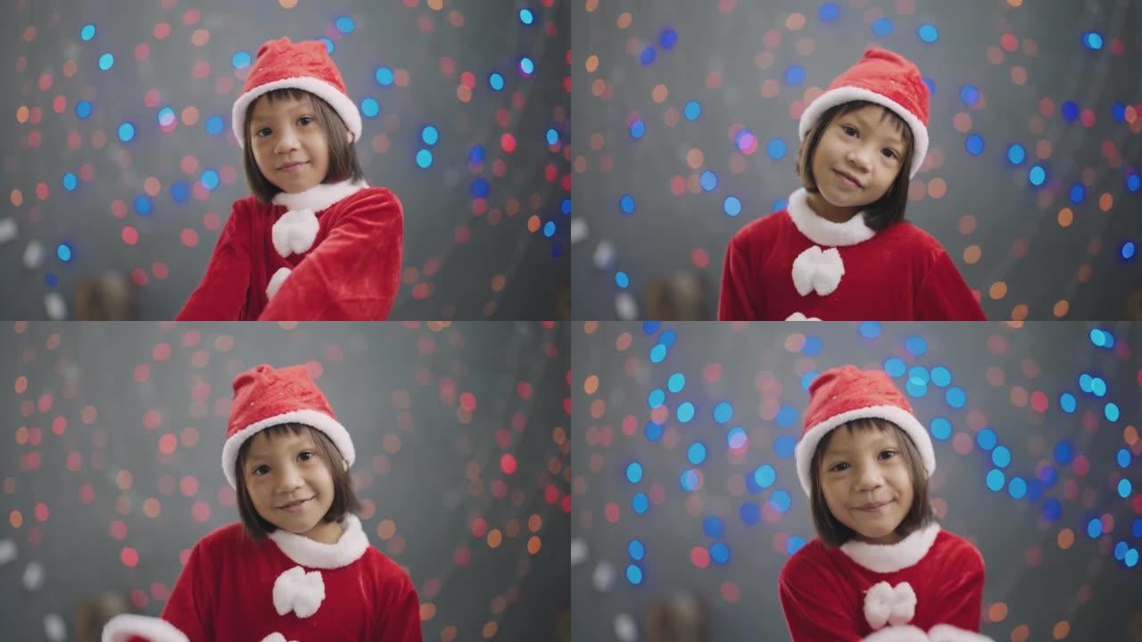 穿着圣诞老人服装的小女孩在圣诞节在家跳舞。
