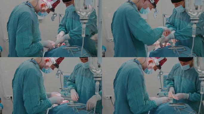 医疗小组使用医用线对淋巴结进行手术，并用医用剪刀切割多余的部分