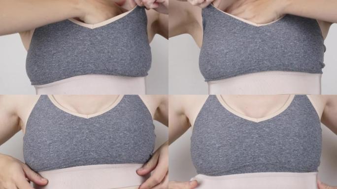 女人在运动胸罩中调整乳房