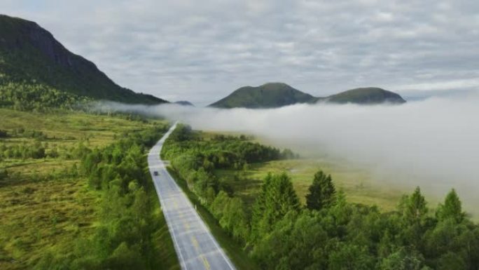 Scenic aerial view of car on the road through Norw