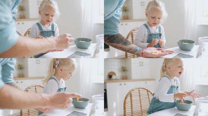 微笑的女儿从父亲的手掌里把木饼放在盘子里