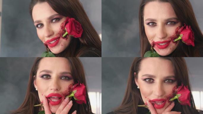 一个女孩嘴里拿着一朵红玫瑰的肖像。万圣节化妆，玫瑰花在嘴里。