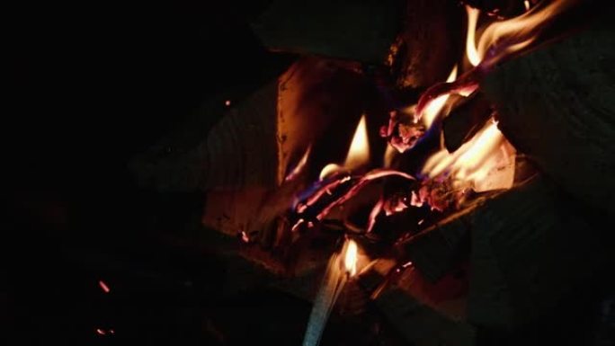 Kindling firewood in the fireplace with a gas burn