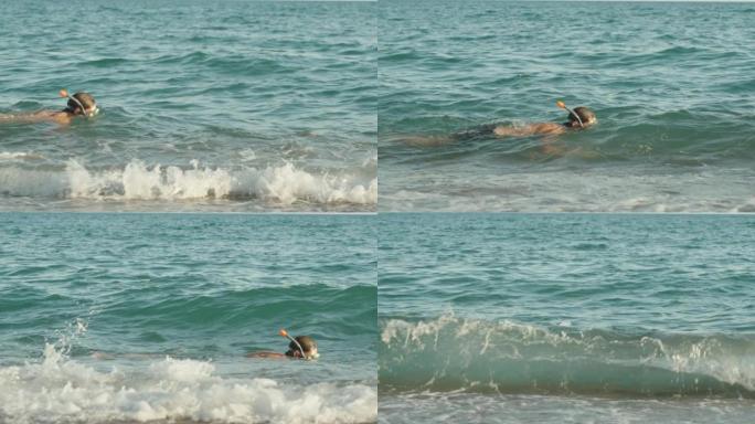 一个戴着水肺潜水面具的男人在海浪上游泳，慢动作