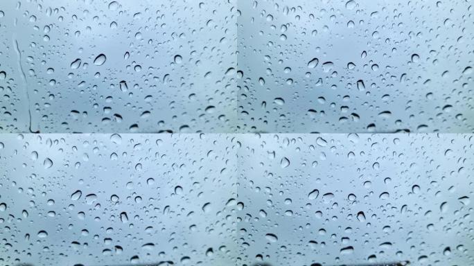 近距离观看时，雨滴从车窗上流下。