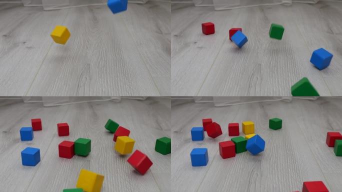 儿童游戏木制玩具块掉到地板上。慢动作。