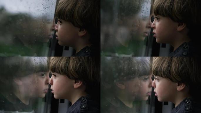 忧郁的小男孩靠在火车窗上，看着雨天经过的风景。小孩旅行