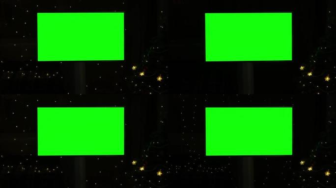 黑色背景上的绿屏电视样机，圣诞节时闪烁