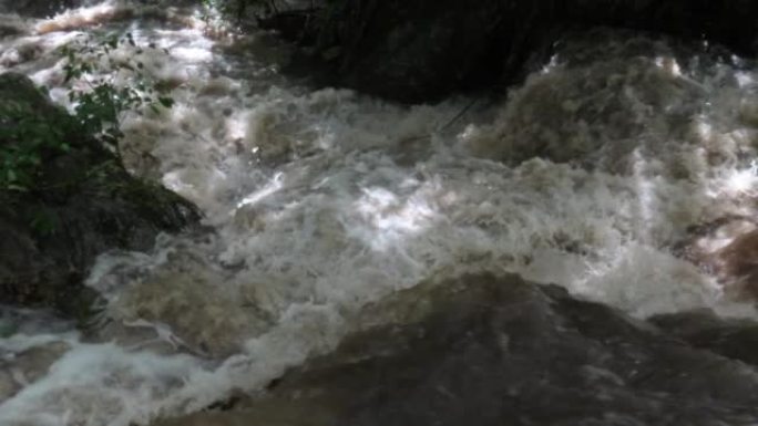 Stream water in muddy flood river