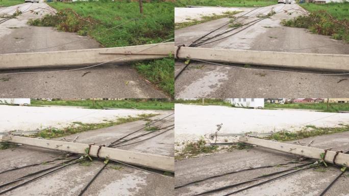 热带飓风过后倒下的电力线杆和电缆。自然灾害的后果
