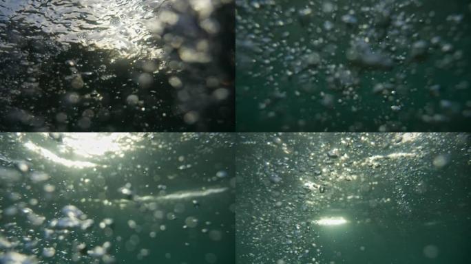 溺水。试图捕捉水面上方的空气。不同形式和形状的气泡在水中。