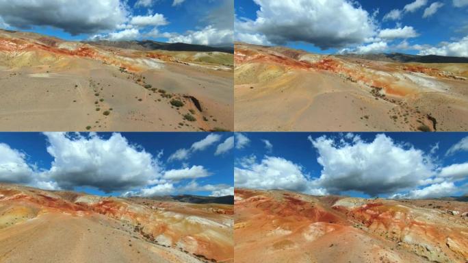 惊人的丰富多彩的地质构造图案，类似于火星景观，无人机镜头。彩色砂岩山的鸟瞰图。