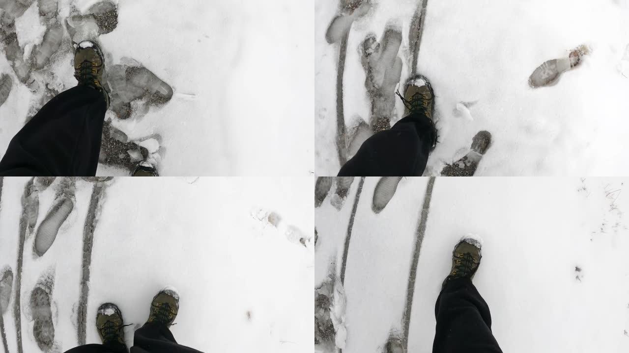 迷失的徒步旅行者在雪中沿着铁轨行走的低视野