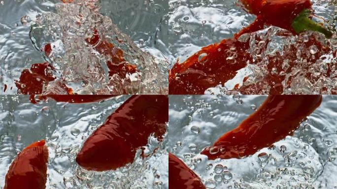红色辣椒粉落水光滑表面特写。有机热蔬菜飞溅