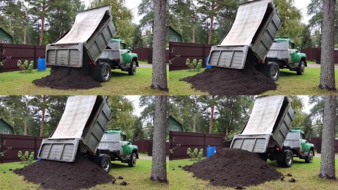 自卸车将土壤卸载到地面。自卸车卸货过程。
