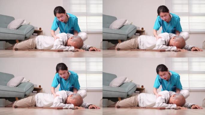 亚洲护理员帮助老年男性免于摔倒在地。老年男性患者接受物理治疗时心脏病发作。护士协助救援概念。