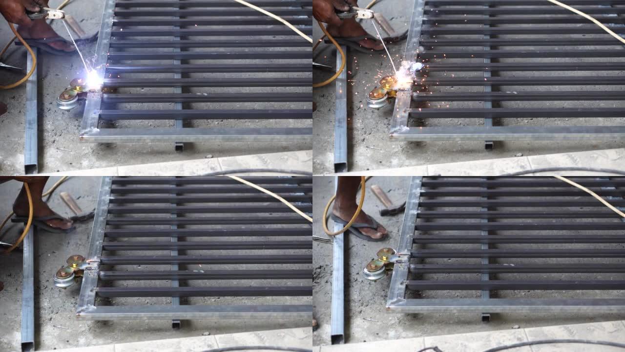 专业工人在建筑工地焊接钢铁，制造铁门