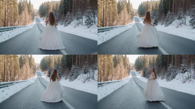 穿着婚纱的新娘在冬季白雪皑皑的松树林中的沥青路面上跳舞。