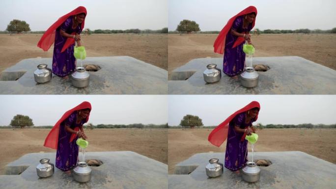 印度妇女从印度拉贾斯坦邦沙漠村庄的井中取水