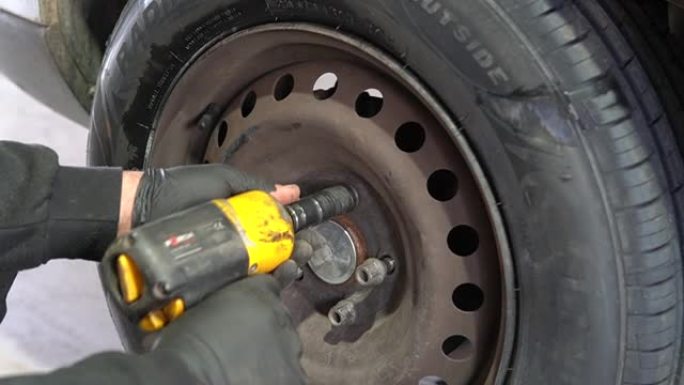 机械师使用高清冲击扳手安装汽车车轮的车轮螺栓