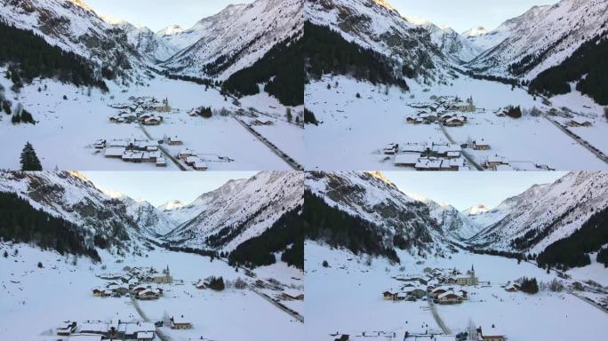 令人惊叹的鸟瞰图的瑞士小村庄位于两个被雪覆盖的高岩山脚下，瑞士滑雪胜地小镇的冬季全景，传统的小屋，酒