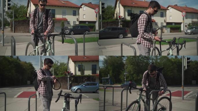 自行车的安全和防盗锁。男性自行车手将自行车锁在德国欧洲城市的街头自行车停车场。盖伊 (Guy) 固定