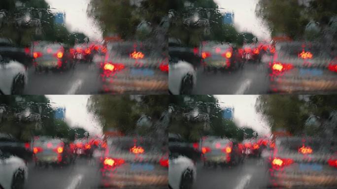 雨天排队等候的汽车，重点关注落在前窗的雨滴，4k慢动作镜头，城市生活概念。