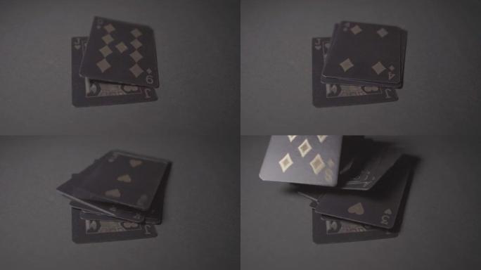 一副黑色和金色的扑克扑克牌落在桌子上