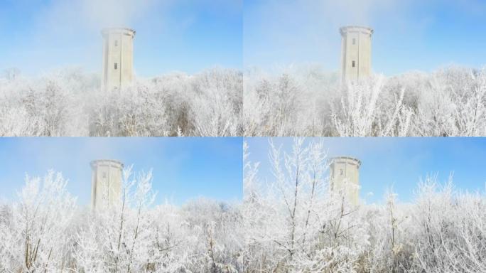 冬冬景观中冰冻森林中间的旧废弃水塔