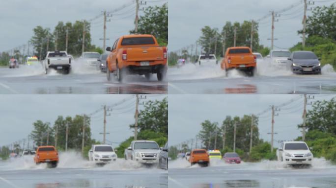 洪水期间，汽车在洪水泛滥的街道上行驶的散焦。