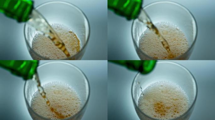 酒精液体喷射鼓泡成透明玻璃俯视图。倒瓶啤酒