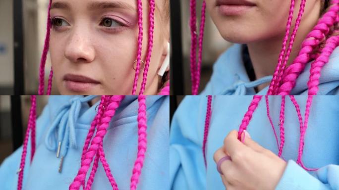 街头背景中一个白种人少女的肖像，她的耳朵里有粉红色的辫子和无线耳机。Z世代风格